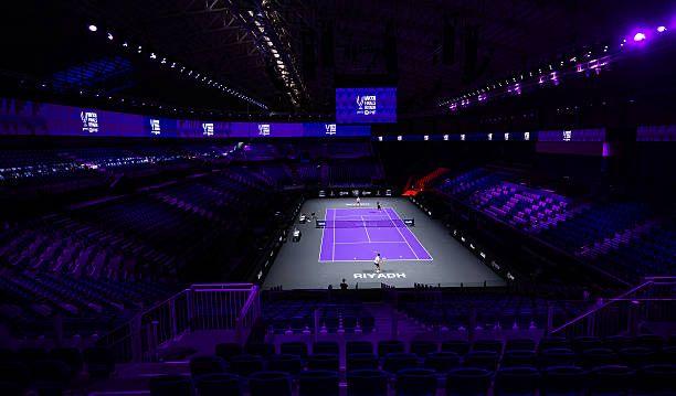 Purple lit tennis stadium representing Saudi Arabia's investment and ownership of professional tennis infrastructure.