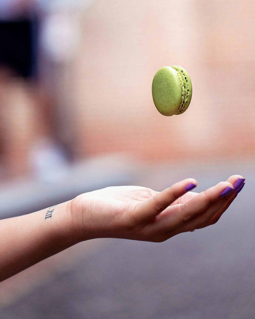 Macaroon being tossed like a tennis ball representing luxury brand partnerships and athlete endorsements in professional tennis